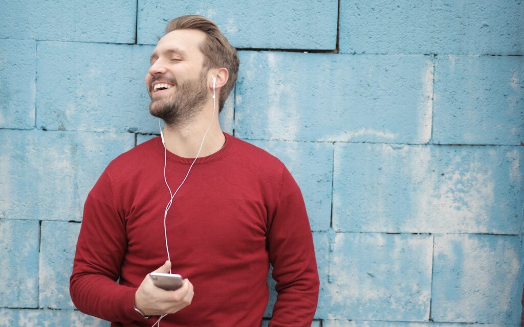 man listerning to music using earphones