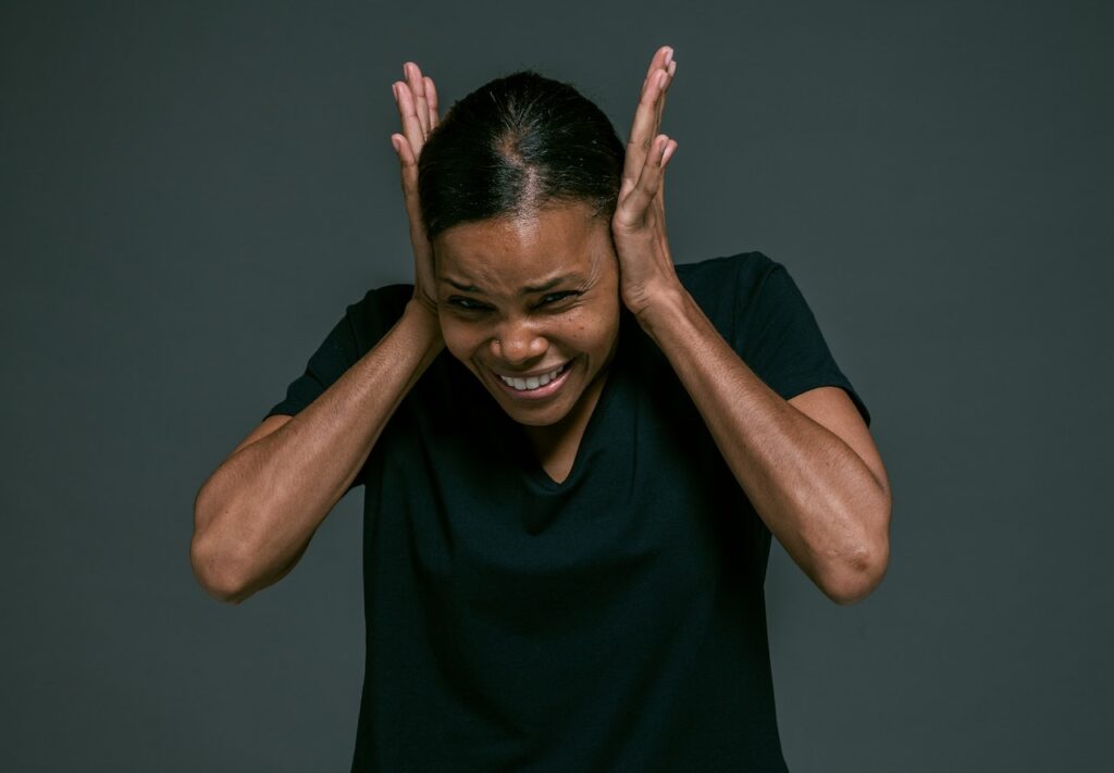 woman covering ears