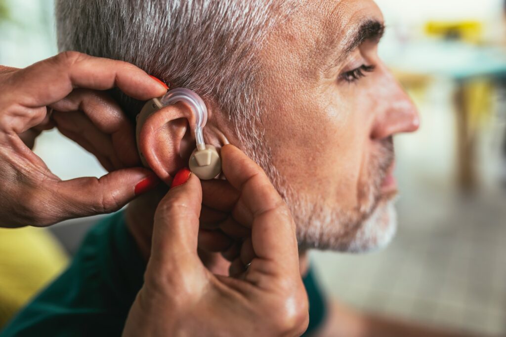 putting on hearing aids